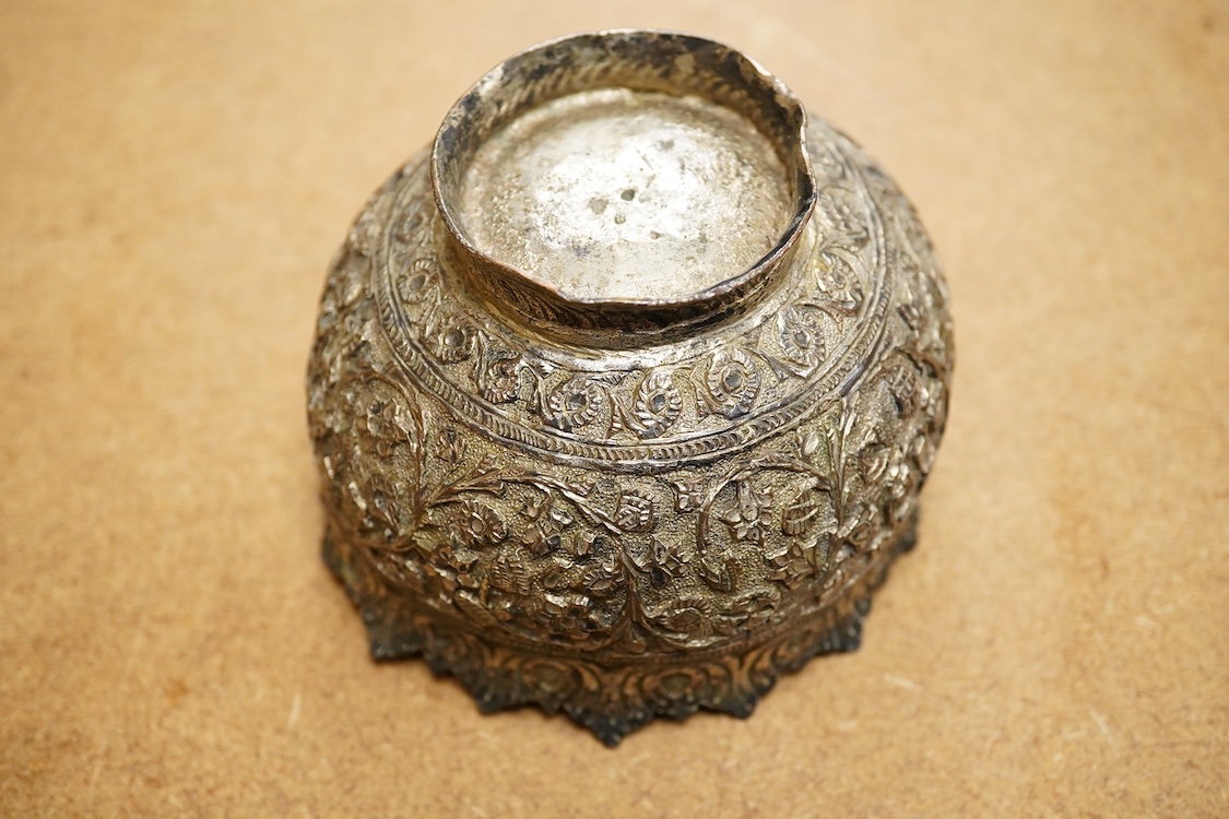A 19th century Kashmiri base metal repousse bowl , with foliate border, diameter 10.8cm.